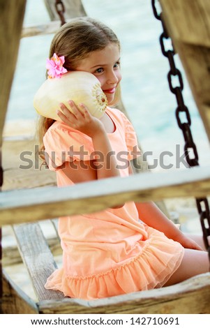 Summer relax, beach resort, summer holiday - lovely girl with shell on the beach