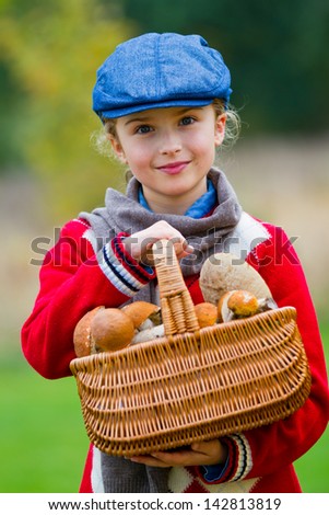 Mushrooms picking, season for mushrooms - lovely girl with basket of picked fresh edible mushrooms