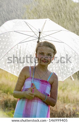 Summer rain - beautiful girl with an umbrella in the rain