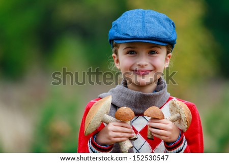 Mushrooms picking, season for mushrooms - lovely girl with picked fresh edible mushrooms
