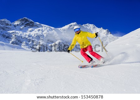Skiing, skier, winter sport - woman skiing downhill