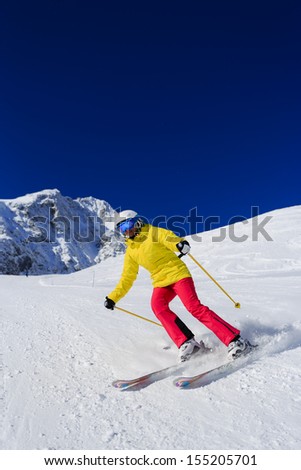 Ski, skier, winter sport - woman skiing downhill