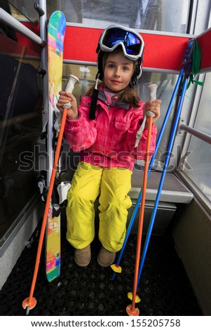 Ski, ski cable car, skier, ski resort - happy girl in cable car