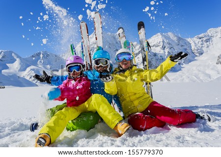 Skiing, winter, snow,  skiers, sun and fun - family enjoying winter vacations