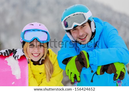 Skiing, snowboarding, winter sports - portrait of young skiers, couple having fun on ski