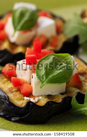 Grilled eggplant with feta cheese, red peppers and basil