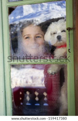 Winter holidays, ski holidays, apres ski - child with puppy  in a room apartment