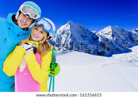 Skiing, snowboarding, winter sports - portrait of young skiers, couple having fun on ski