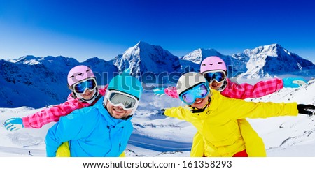 Ski, winter, snow, skiers, sun and fun - family enjoying winter vacations