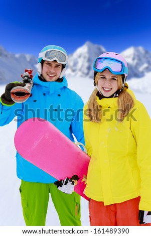 Skiing, winter sports - portrait of young skiers, couple having fun on ski