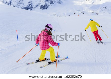 Ski, skiers on ski run - female skiers skiing downhill,  child on ski lesson