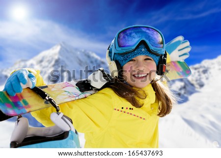 Ski, winter fun - lovely skier girl enjoying ski holiday