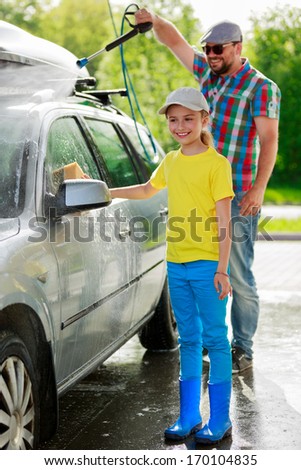 Car-washing - Young girl with father in carwash.