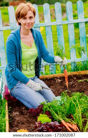 Gardening, cultivation - beautiful woman and organically grown carrots