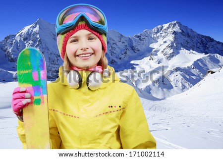 Ski, winter fun - lovely skier girl enjoying ski holiday