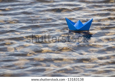 paper ship in water