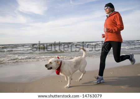Running with dog on the beach