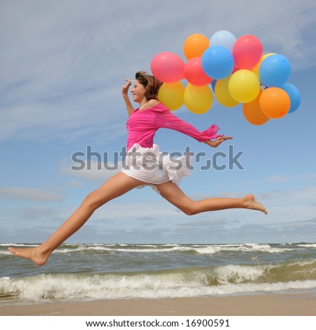 stock photo Teenager playing with balloons on the beach