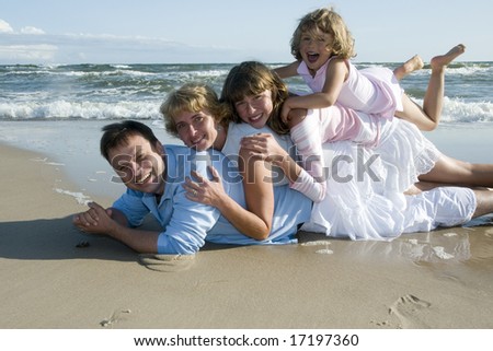 Happy family playing together on the beach