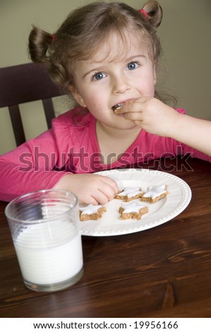 Little girl eating cookies