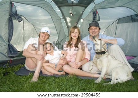 Happy family with dog in tent