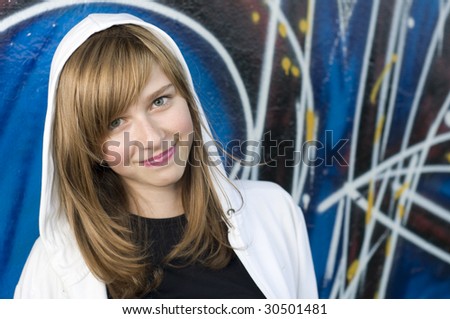 Smiling young girl on graffiti background
