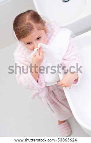 Little girl blowing nose
