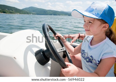 Little girl  driving a motor boat