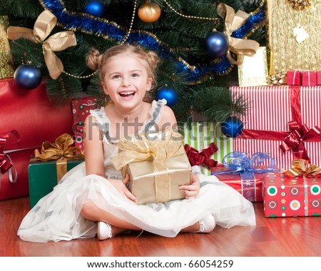 Happy little girl with Christmas gifts