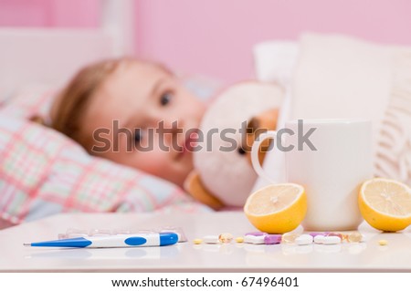 Medicines and hot tea in front, sick girl with teddy bear in bed ( No-name teddy bear )