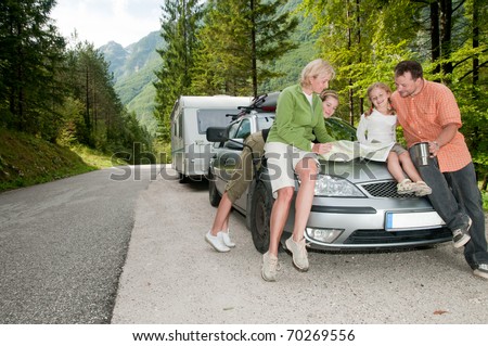 Family with camping car on the road
