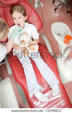 Dental checkup -  little patient at dental clinic (no-name toy)