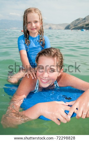 Body-boarding - girls playing in the sea