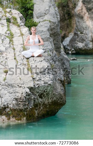 In  harmony with  nature - young girl exercising on rocks