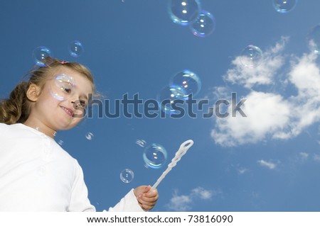 Soap bubbles - little girl blowing bubbles