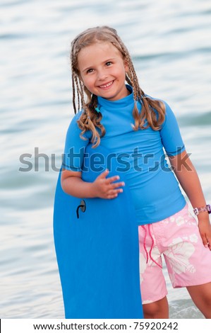 Surfer girl at the beach - portrait