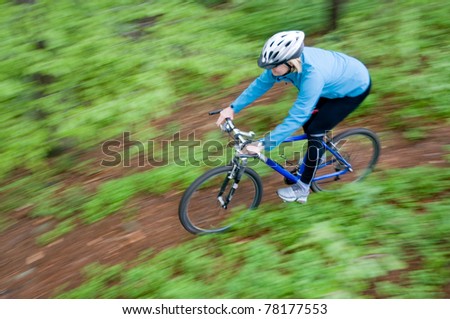 Bike riding - woman on bike (intentional motion blur)