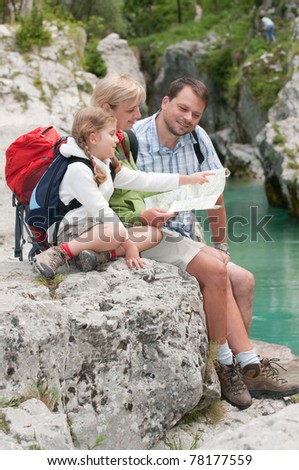 Mountain trek - family crossing through river