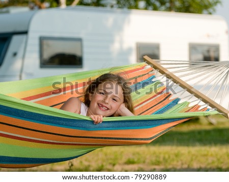 Summer vacation in camping - Cute girl in the colorful hammock