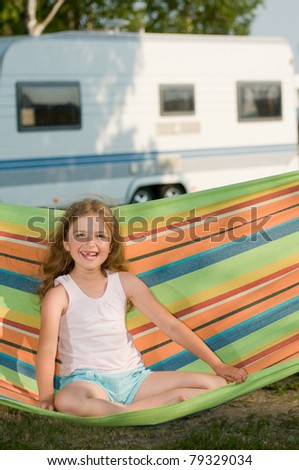 Summer vacation in camping - Cute girl in the colorful hammock