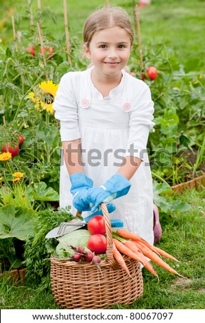 Vegetable garden - little gardener with harvests of healthy vegetables