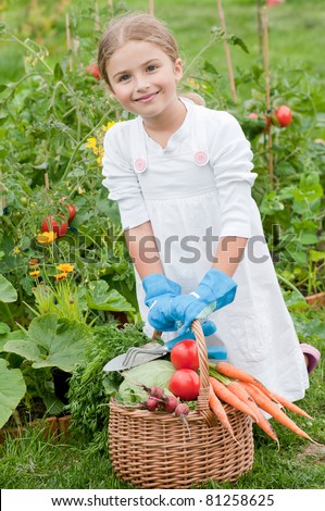 Harvests of vegetables - little gardener with the basket of ecological harvests