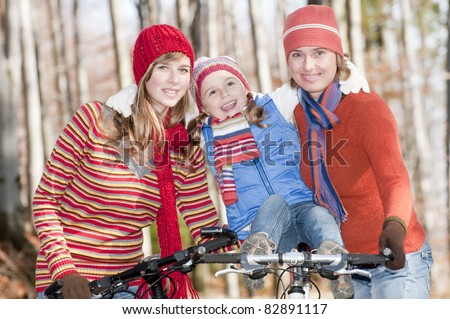 Autumn biking - happy family biking in autumn forest