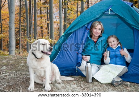 Autumn camping - family with dog in tent