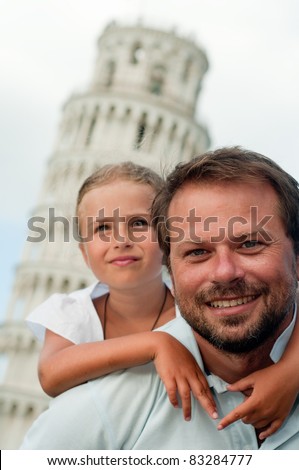 Pisa -  travel to famous places in Europe, family portrait  in background the Leaning Tower in Pisa, Italy