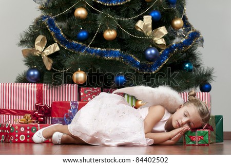 Christmas time - little angel sleeping under the Christmas tree