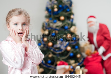 Merry Christmas - Santa Claus is coming - surprised little girl in Christmas night