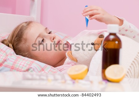 Fever, cold and flu - Medicines and hot tea in front, sick girl with teddy bear in bed ( No-name teddy bear )