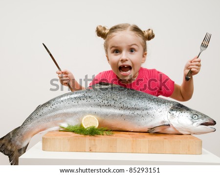 Healthy eating seafood - little girl and big  fish