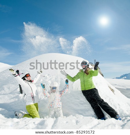 Winter, ski, sun and fun - happy skiers playing in snow (copy space)